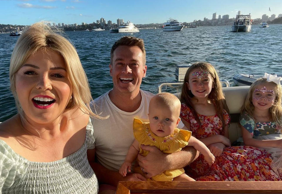 Grant and Chezzi Denyer are pictured on a boat with their three daughters.