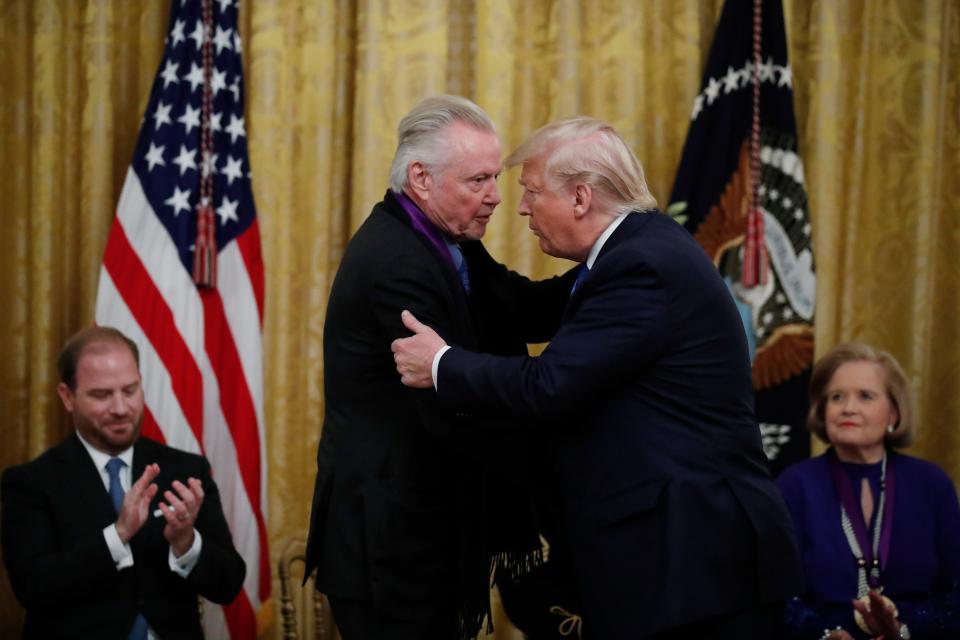 President Donald Trump greets Jon Voight  in the East Room of the White House.