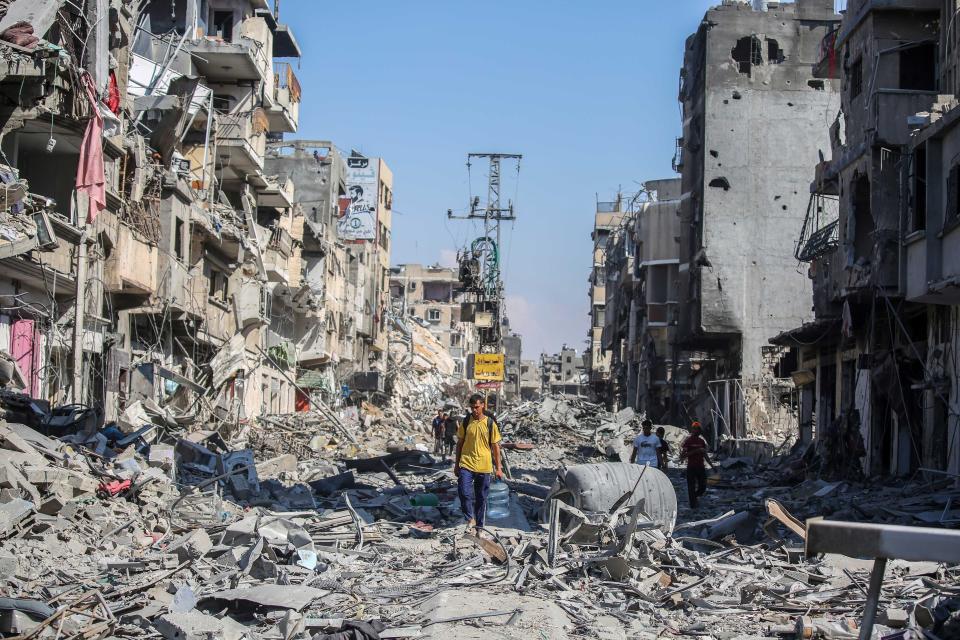 People inspect damage and remove items from their homes following Israeli airstrikes on April 07, 2024 in Khan Yunis, Gaza.