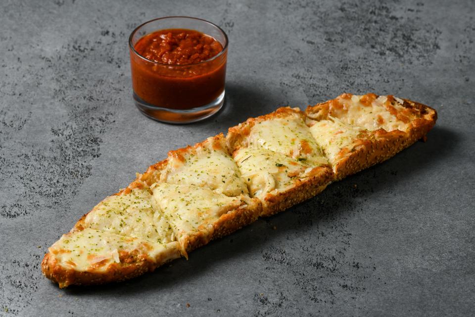 Chef Christian Petroni's garlic bread, with a side of sauce for dipping, is now featured at Yankee Stadium, about 10 minutes away from where he grew up in the Bronx.