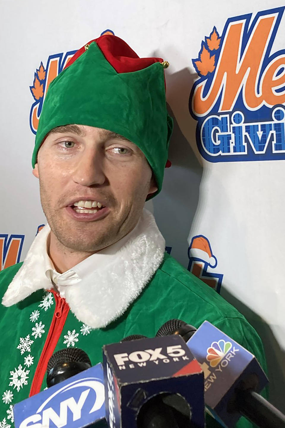New York Mets' Brandon Nimmo is dressed as an elf as he speaks to the media at the Mets holiday party at Citi Field in New York on Thursday, Dec. 15, 2022. (AP Photo/Ron Blum)