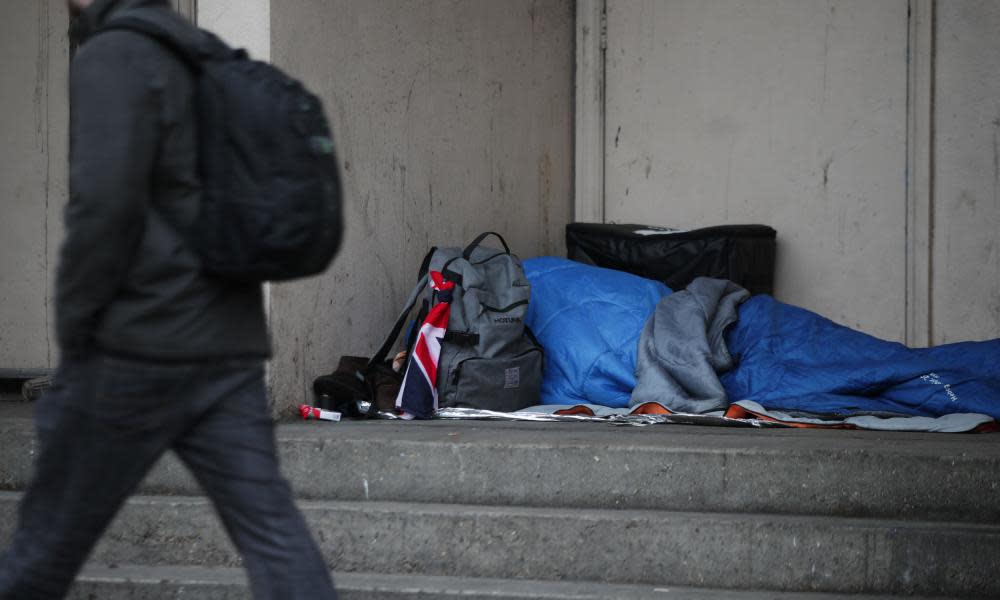 A homeless person sleeping rough in a doorway