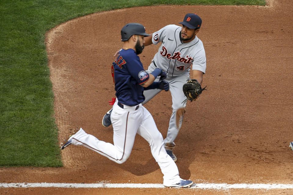 Detroit Tigers first baseman Jeimer Candelario, right, tags out Minnesota Twins' Marwin Gonzalez on a ground ball in the fourth inning of the second game of a baseball doubleheader Friday, Sept. 4, 2020, in Minneapolis. (AP Photo/Bruce Kluckhohn)