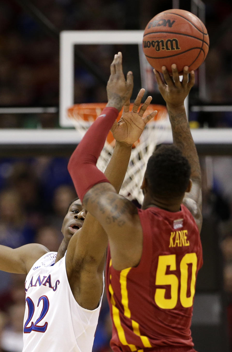 Kansas' Andrew Wiggins (22) tries to block a shot by Iowa State's DeAndre Kane (50) during the first half of an NCAA college basketball game in the Big 12 men's tournament on Friday, March 14, 2014, in Kansas City, Mo. (AP Photo/Charlie Riedel)