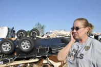 Becky Braley reacts in front of the wreckage left behind after a tornado destroyed her in-laws RV at the Roadrunner RV Park in Oklahoma City, Oklahoma May 7, 2015. About a dozen people were injured by a series of tornadoes that touched down southwest of Oklahoma City, part of a storm system that flattened structures and caused severe flooding in several Great Plain states, officials said on Thursday. REUTERS/Nick Oxford TPX IMAGES OF THE DAY