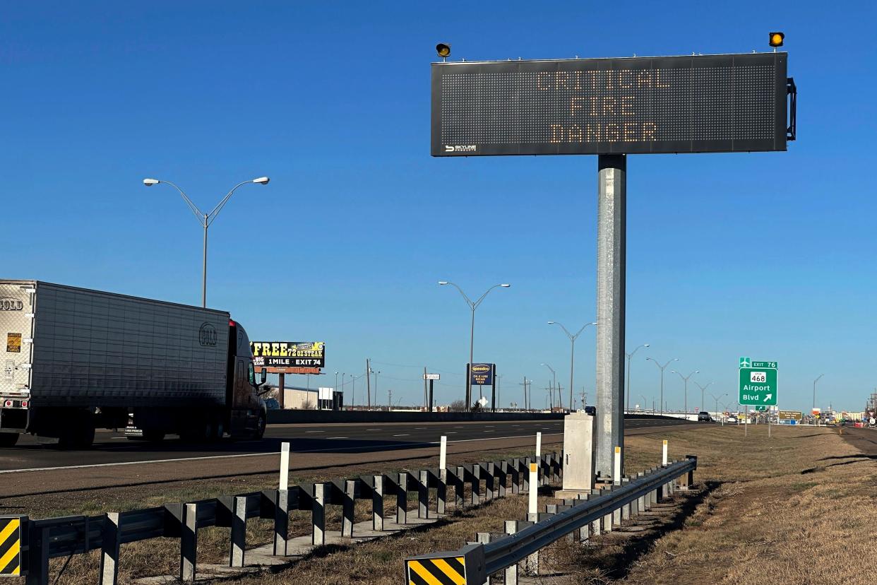 A truck passes a warning sign about the Smokehouse Creek Fire on a highway in Amarillo, Texas on Saturday, March 2, 2024. Firefighters battling the largest wildfire in Texas history face increasingly difficult weather (AP Photo/Ty O'Neil) ORG XMIT: TXTO101