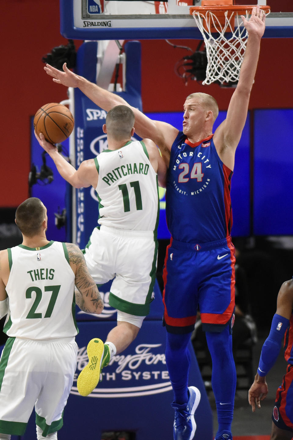 Boston Celtics guard Payton Pritchard, left, drives against Mason Plumlee during the first half of an NBA basketball game Sunday, Jan. 3, 2021, in Detroit. (AP Photo/Jose Juarez)