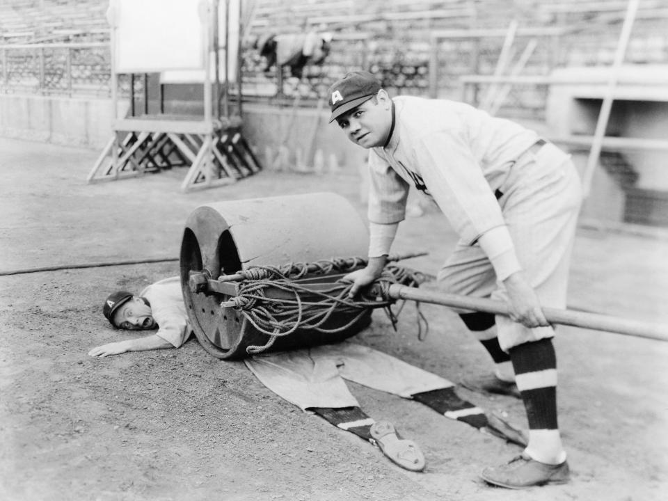 Babe Ruth pretending to roll over Lou Archer in the silent comedy "Babe Comes Home" in 1927.