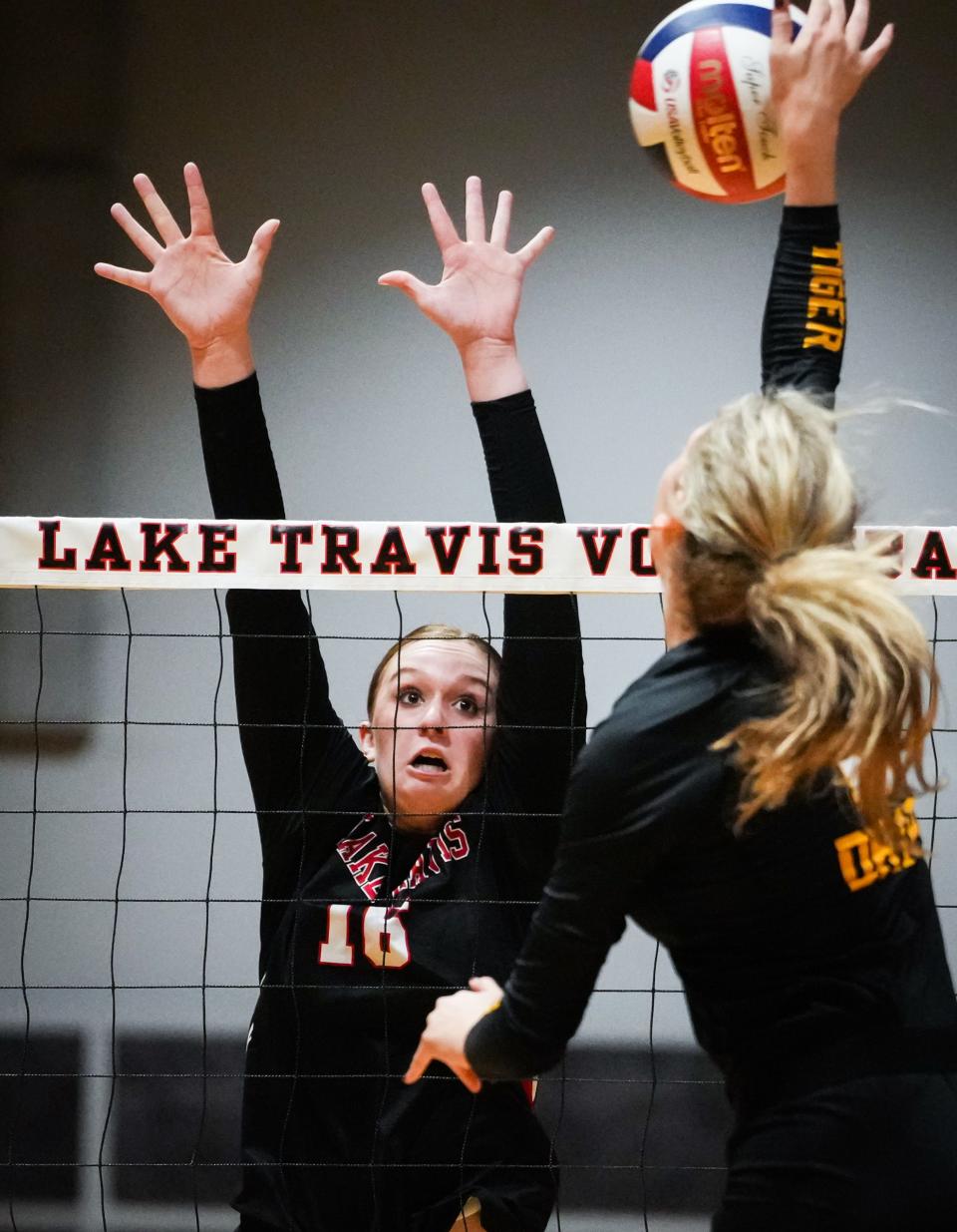 All hands were on deck for Lake Travis on Tuesday night as the Cavs' Adyson Davis jumps to block Riley Certain's shot in a four-set Cavs win over defending state champion Dripping Springs.