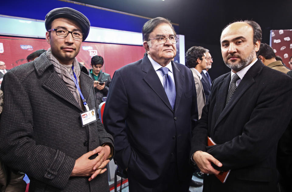 FILE - In this Tuesday, Feb. 4, 2014 file photo, Afghanistan presidential election candidate and former Defense Minister Abdul Rahim Wardak, center, poses for a photo after the first presidential election debate at the Tolo TV building in Kabul, Afghanistan. Wardak, a longtime defense minister until he was removed by parliament in a vote of no confidence in 2012, gave no reason for his withdrawal and he was not throwing his support behind any remaining candidates, he said Sunday, March 16. (AP Photo/Massoud Hossaini, File)