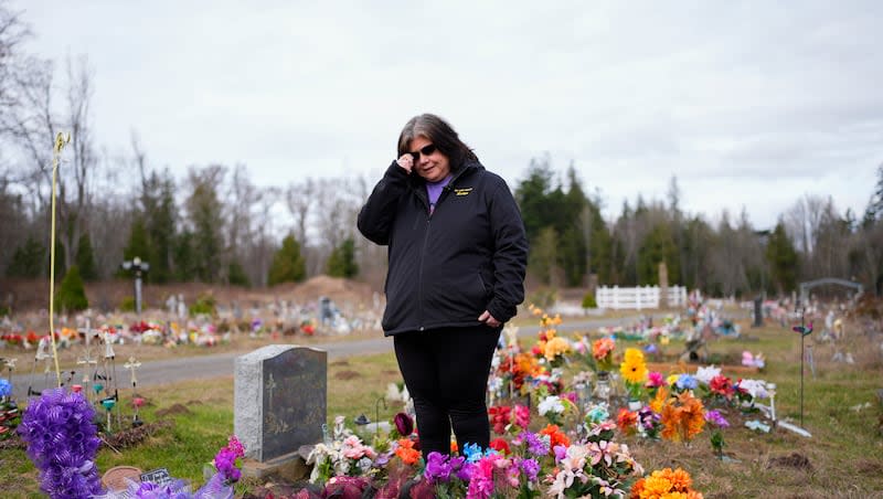 Evelyn Jefferson, a crisis outreach supervisor for Lummi Nation, stands at the grave of her son Patrick George Jr., who died last September due to an overdose of street drugs containing the synthetic opioid carfentanil, at the Lummi Nation cemetery on tribal reservation lands, Thursday, Feb. 8, 2024, near Bellingham, Wash. Jefferson had to wait a week to bury her son due to several other overdose deaths in the community. The latest Centers for Disease Control and Prevention data found life expectancy increased, but so did overdose deaths.