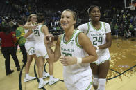 Oregon's Sabrina Ionescu, center, celebrates with her teammates Lydia Giomi, left, Erin Boley and Ruthy Hebard, right, after defeating Kansas State 89-51 in an NCAA college basketball game in Eugene, Ore., Saturday, Dec. 21, 2019. (AP Photo/Chris Pietsch)
