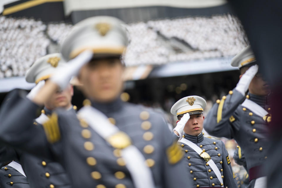 FILE - Graduating cadets salute during the graduation ceremony of the U.S. Military Academy class of 2021, Saturday, May 22, 2021, in West Point, N.Y. "Duty, Honor, County" has been the motto of the U.S. Military Academy at West Point since 1898. The motto isn't changing, but a decision to take those words out of the school's lesser-known mission statement is generating outrage in certain quarters. (AP Photo/Eduardo Munoz Alvarez, File)