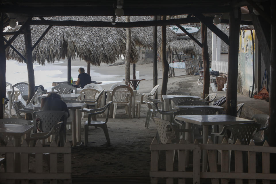 A few visitors visit a beachside restaurant in the coastal town of Las Peñitas, Nicaragua, Tuesday, Sept. 11, 2018. Economists estimate that since the unrest started in April, 200,000 jobs have been shed, including as many as 70,000 in the tourism sector, which has become Nicaragua's top source of foreign currency in the past two years. (AP Photo/Alfredo Zuniga)