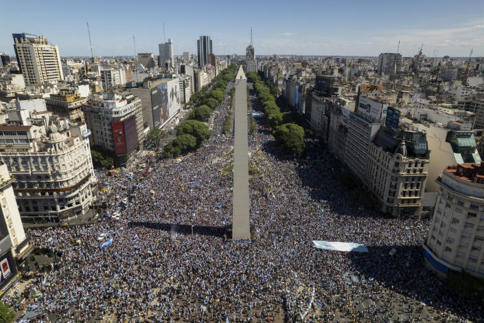 Argentine soccer fans descend on the capital's Obelisk to celebrate their team's World Cup victory over France, in Buenos Aires, Argentina, Sunday, Dec. 18, 2022. (AP Photo/Rodrigo Abd)