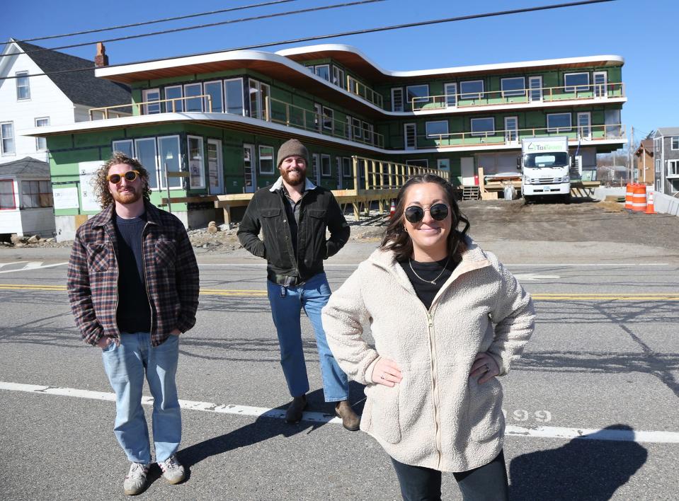 Artists Dan Dellapasqua and Kyle Nelson along with COO at Crane Hotel Group Haven Hatch pose outside of the Nevada Motel across from Long Sands Beach March 8, 2024. The motel is expected to open in June and will feature original art throughout.