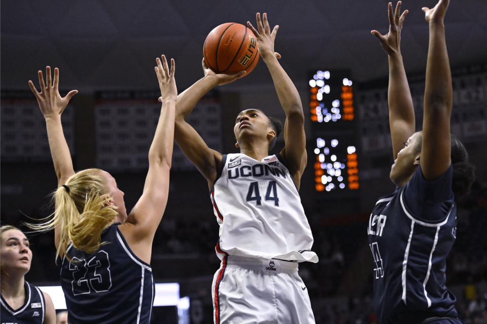 UConn's Aubrey Griffin (44) shoots between Butler's Jordan Meulemans (23) and Kelsy Taylor (44) in the second half of an NCAA college basketball game, Saturday, Jan. 21, 2023, in Storrs, Conn. (AP Photo/Jessica Hill)