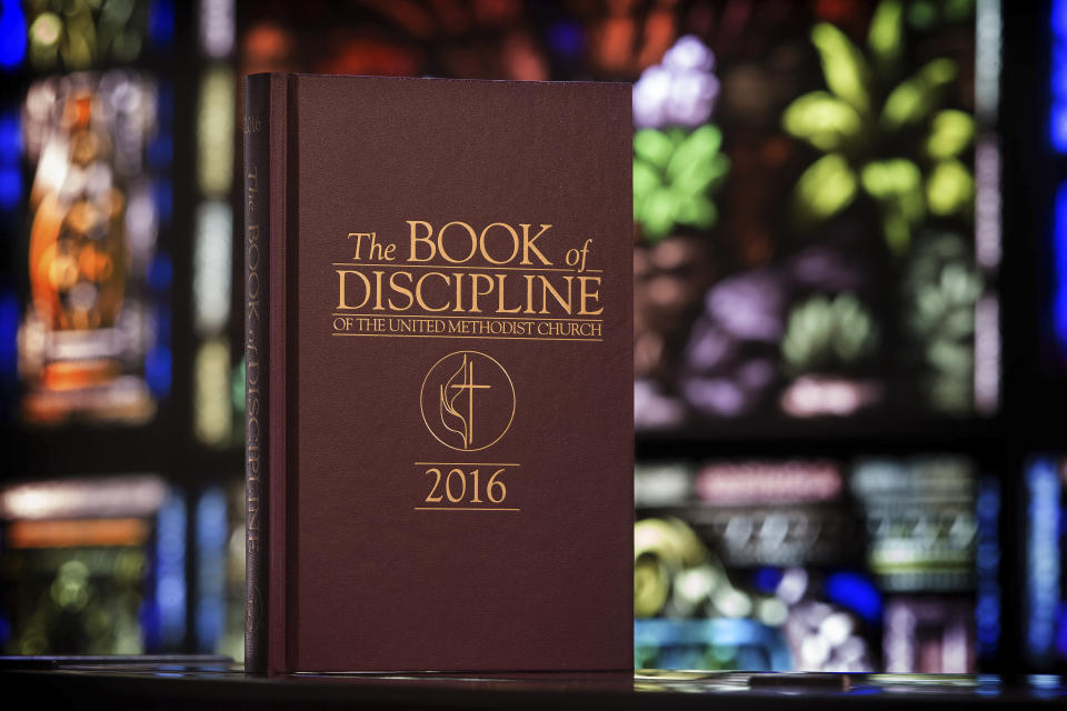 This 2017 photo provided by the United Methodist News Service shows the Book of Discipline which contains the rules that guide The United Methodist Church. The church convenes its top legislative assembly Saturday, Feb. 23, 2019, for a high-stakes four-day meeting likely to determine whether America's second-largest Protestant denomination will fracture due to long-simmering divisions over same-sex marriage and the ordination of LGBT clergy. (Mike DuBose/UMNS via AP)