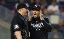 New York Yankees manager Aaron Boone talks to umpire Lance Barrett (16) during the second inning of the team's baseball game against the Toronto Blue Jays, Wednesday, Sept. 20, 2023, in New York. (AP Photo/Noah K. Murray)