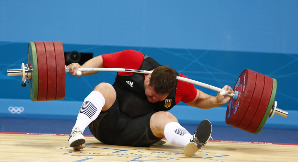 Germany's Matthias Steiner is injured while his weights fall during the men's 105kg Group A snatch weightlifting competition at the ExCel venue during the London 2012 Olympic Games August 7, 2012. REUTERS/Grigory Dukor (BRITAIN - Tags: OLYMPICS SPORT WEIGHTLIFTING TPX IMAGES OF THE DAY) FOR BEST QUALITY IMAGE: ALSO SEE GF2E88U0TO901.