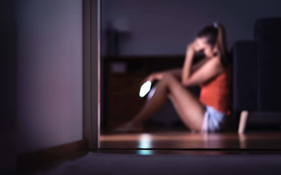 teenager with smartphone in her room sitting on floor - Tero Vesalainen