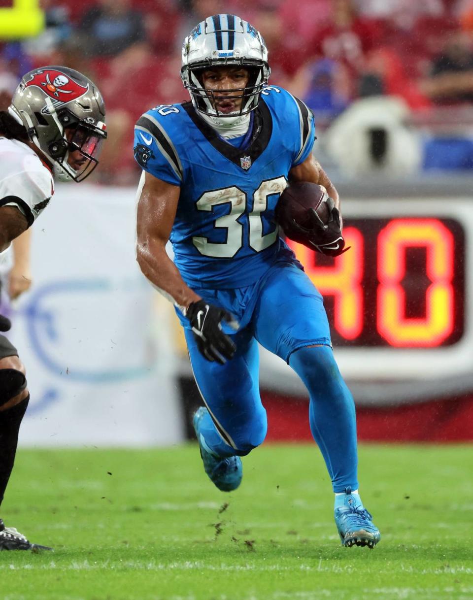 Dec 3, 2023; Tampa, Florida, USA; Carolina Panthers running back Chuba Hubbard (30) runs with the ball against the Tampa Bay Buccaneers during the first half at Raymond James Stadium. Hubbard had 104 yards and two touchdowns in Carolina’s 21-18 loss to Tampa Bay.