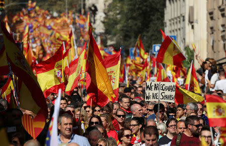 People wave Spanish and Catalan flags as they attend a pro-union demonstration organised by the Catalan Civil Society organisation in Barcelona, Spain, October 8, 2017. REUTERS/Albert Gea