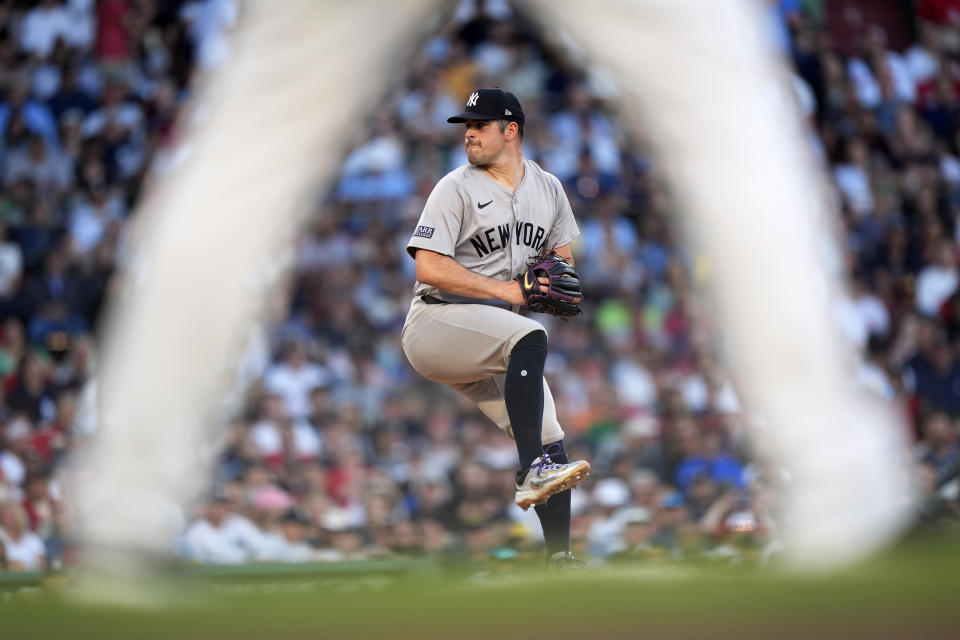 New York Yankees pitcher Carlos Rodón winds up during the first inning of the team's baseball game against the Boston Red Sox on Saturday, June 15, 2024, in Boston. (AP Photo/Robert F. Bukaty)