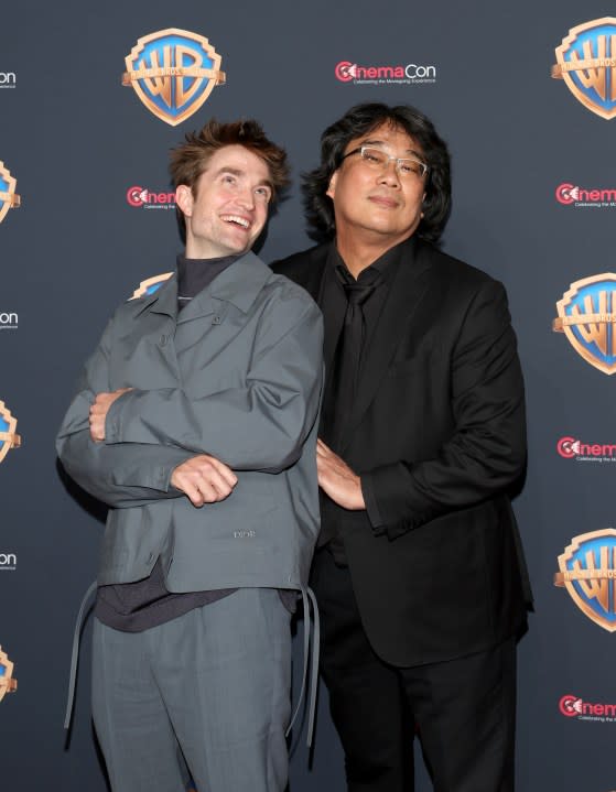 LAS VEGAS, NEVADA – APRIL 09: (L-R) Robert Pattinson and Bong Joon-ho attend the Warner Bros. Pictures Presentation during CinemaCon 2024 at The Colosseum at Caesars Palace on April 09, 2024 in Las Vegas, Nevada. (Photo by Gabe Ginsberg/Getty Images)