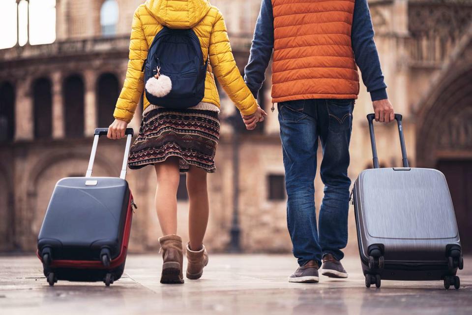 <p>Getty</p> A stock image of two people with suitcases