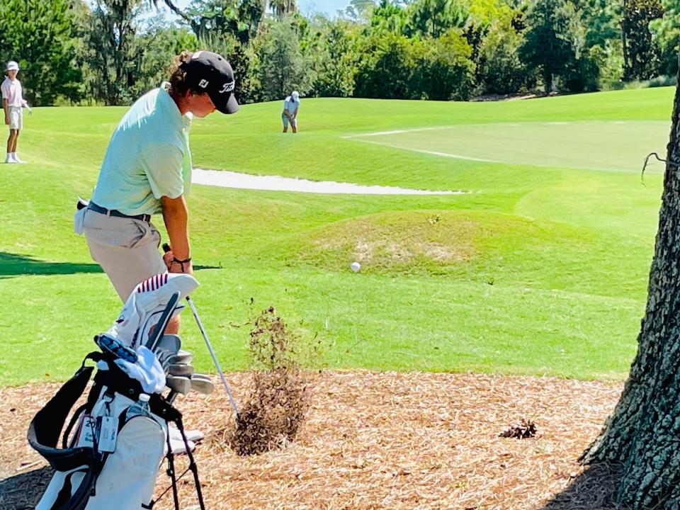 Carson Brewer of Ponte Vedra Beach plays out of a patch of pine straw during the 2021 Junior Players Championship at the TPC Sawgrass Players Stadium Course.