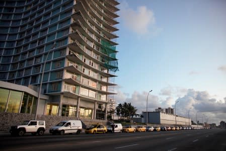 Cars line up for gas at the seafront Malecon in Havana