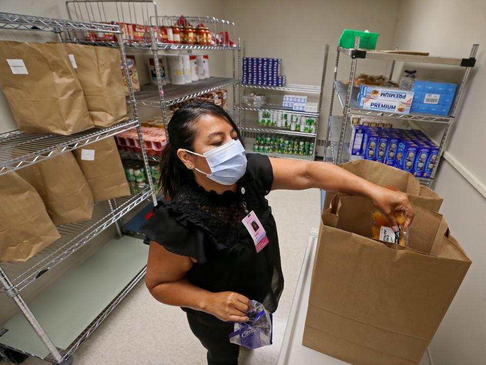 Nubia Rojas, patient navigator and social worker, fills food orders for patients with specific needs such as food insecurities, hypertension, diabetes and anemia at Ascension SE Wisconsin Hospital - St. Joseph Campus . After meeting with physicians and undergoing a health screening, patients have an opportunity to receive foods based on their specific conditions.