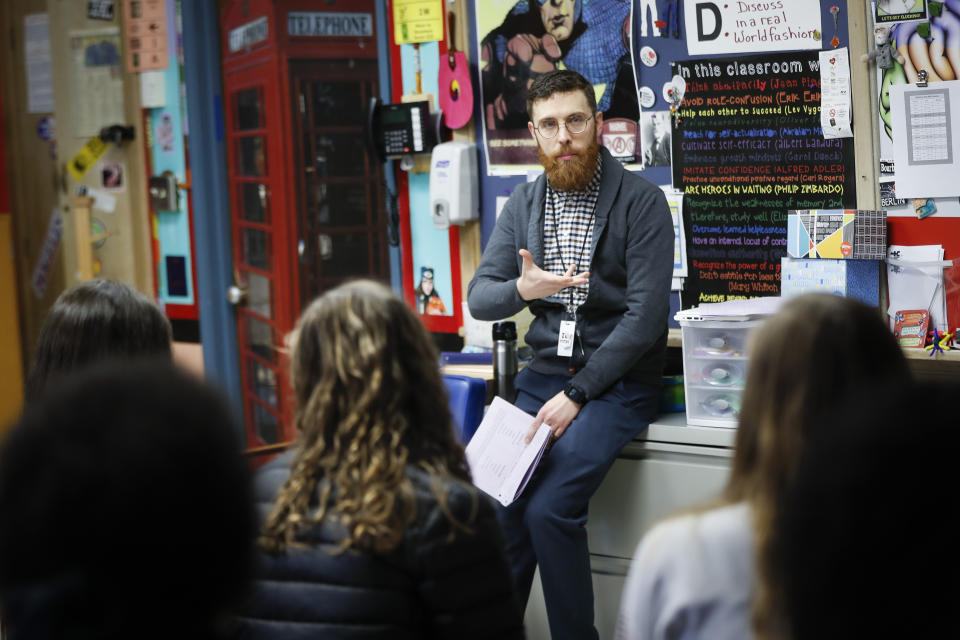 In this Thursday, Jan. 24, 2019, photo social studies teacher Jonathan Duffy co-leads the introductory class of their American Thought and Political Radicalism course at Thomas Worthington High School, in Worthington, Ohio. (AP Photo/John Minchillo)