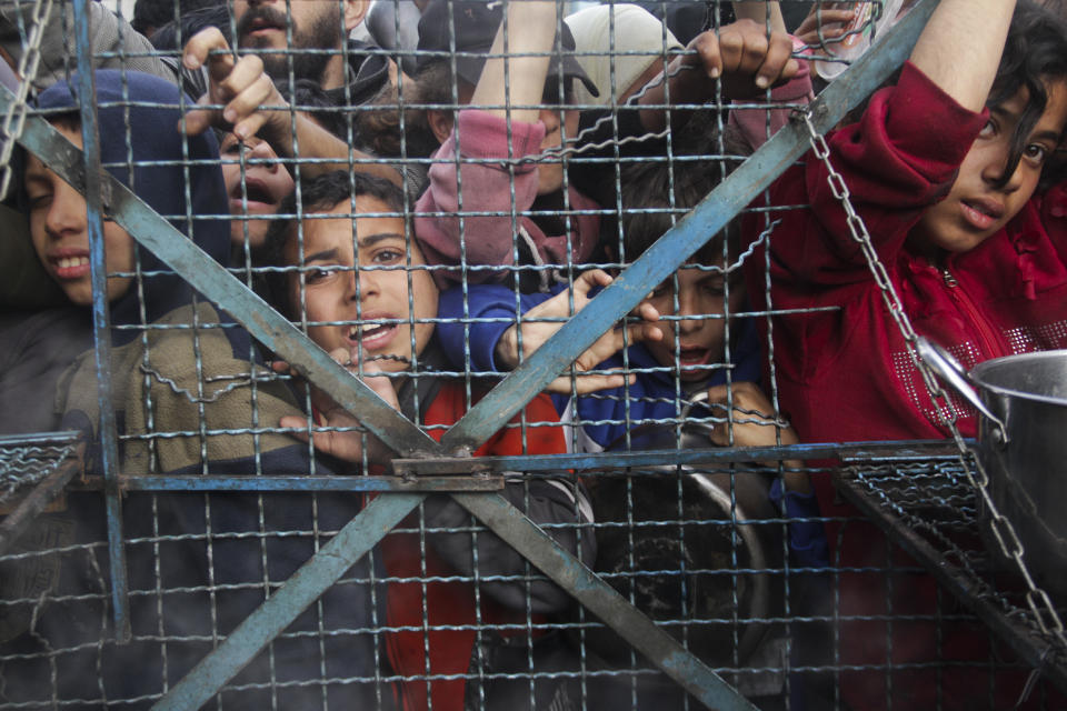 Palestinians line up to receive free meals at Jabaliya refugee camp in the Gaza Strip on Monday, March 18, 2024. (AP Photo/Mahmoud Essa)