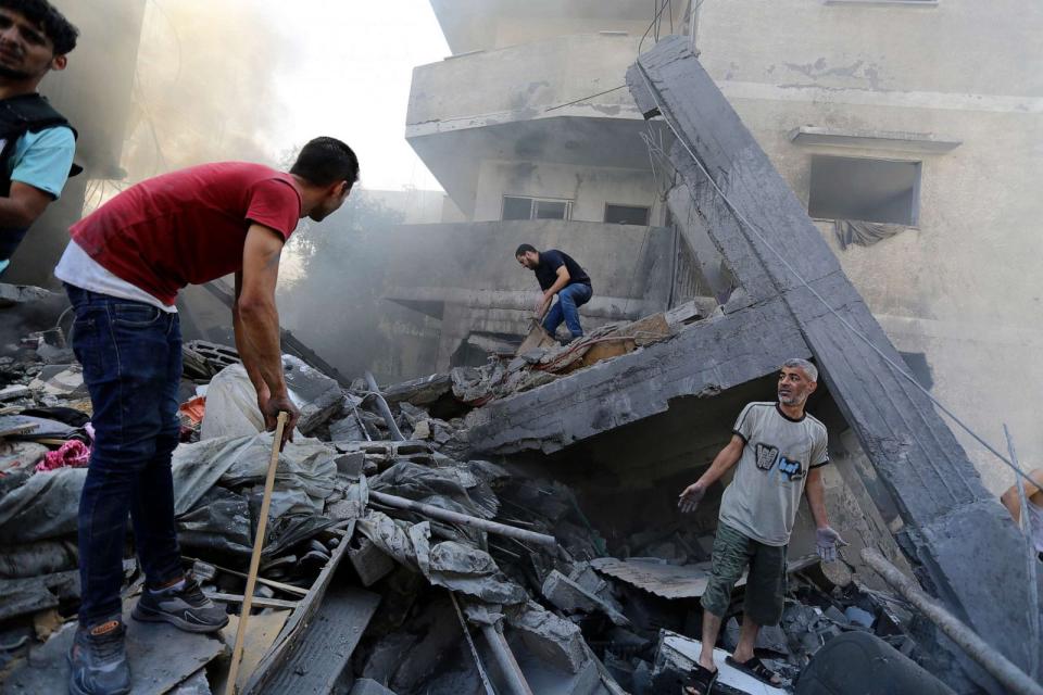 PHOTO: Palestinians look for survivors after Israeli airstrikes in Gaza City, Gaza Strip, Oct. 18, 2023. (Abed Khaled/AP)