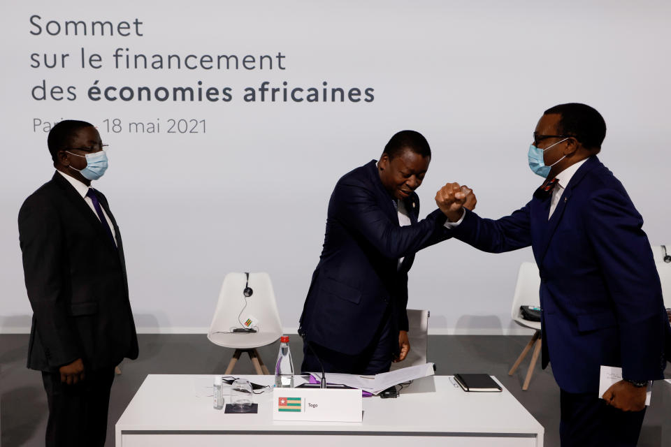 Chad's Prime Minister Albert Pahimi Padacke, left, looks on as the president of the African Development Bank Akinwumi Adesina, right, salutes Togo's President Faure Gnassingbe, center, before the opening session at the Summit on the Financing of African Economies Tuesday, May 18, 2021 in Paris. More than twenty heads of state and government from Africa are holding talks in Paris with heads of international organizations on how to revive the economy of the continent, deeply impacted by the consequences of the COVID-19 pandemic. (Photo by Ludovic Marin, Pool via AP)