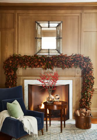 <p>PHOTOGRAPHS BY BRIE WILLIAMS; STYLING BY G. BLAKE SAMS</p> In the renovated family room, Berry updated the original fireplace. She emphasized its 5-foot height with angled plasterwork, topped it with a contrasting antique mirror, and flanked it with leather chairs.