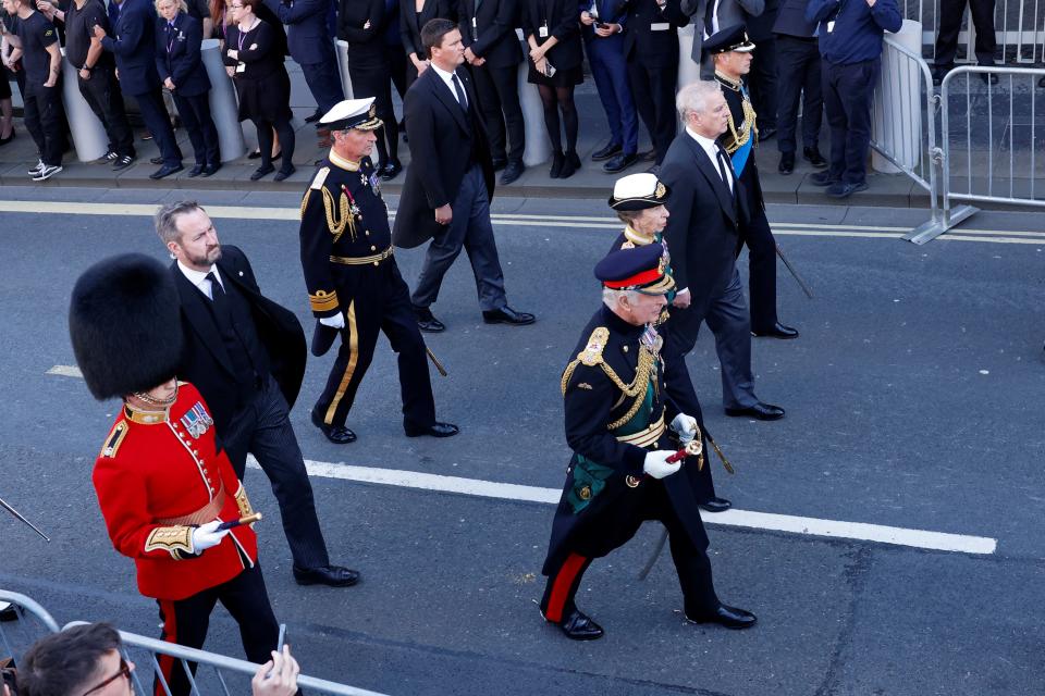 Britain's King Charles III (4R), Britain's Princess Anne, Princess Royal (3R), Britain's Prince Andrew, Duke of York (2R) and Britain's Prince Edward, Earl of Wessex (R) walk behind the procession of Queen Elizabeth II's coffin, from the Palace of Holyroodhouse to St Giles Cathedral, on the Royal Mile on September 12, 2022, where Queen Elizabeth II will lie at rest. - Mourners will on Monday get the first opportunity to pay respects before the coffin of Queen Elizabeth II, as it lies in an Edinburgh cathedral where King Charles III will preside over a vigil. (Photo by Odd ANDERSEN / POOL / AFP) (Photo by ODD ANDERSEN/POOL/AFP via Getty Images)