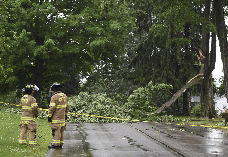 Concord firefighters work at the scene of a downed tree and power line on Main Street on Wednesday, June 10, 2020. Strong storms with heavy winds swept across Jackson County causing power outages, downing trees and damaging property. (J. Scott Park/Jackson Citizen Patriot via AP)