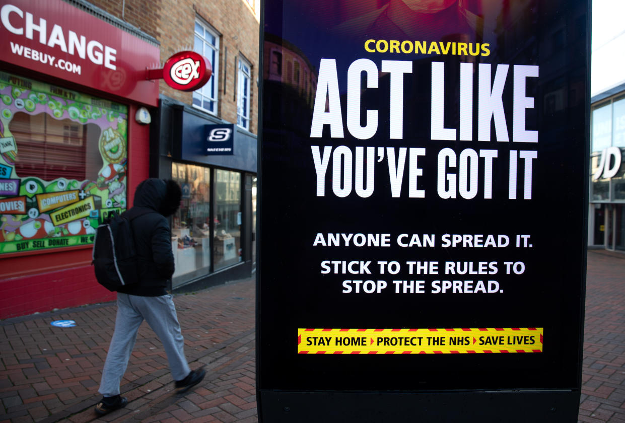 A person passes a 'Act like you've got it' government coronavirus sign on Commercial road in Bournemouth, during England's third national lockdown to curb the spread of coronavirus. Picture date: Friday January 22, 2021. (Photo by Andrew Matthews/PA Images via Getty Images)