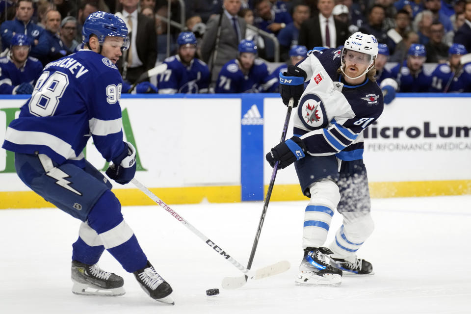 Tampa Bay Lightning defenseman Mikhail Sergachev (98) blocks a shot by Winnipeg Jets left wing Kyle Connor (81) during the first period of an NHL hockey game Wednesday, Nov. 22, 2023, in Tampa, Fla. (AP Photo/Chris O'Meara)