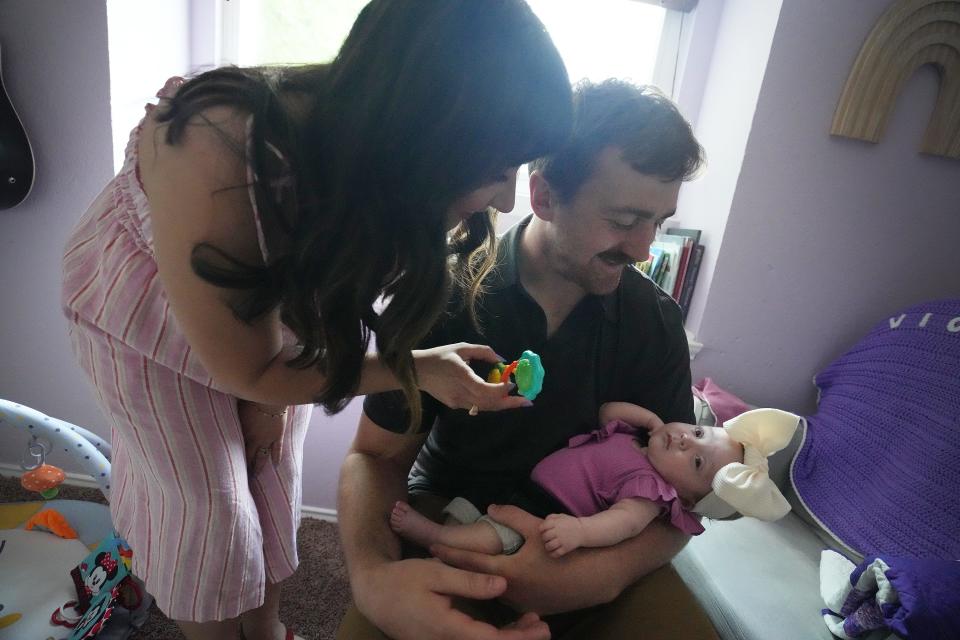 Luci and Philip Hanson play with Violet in her bedroom. Violet was born Nov. 18 at 25 weeks and six days gestation.