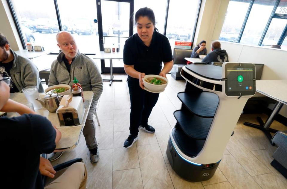 Neeranuch Srichompoo serves dishes to lunchtime diners at Pho 919 in Morrisville.