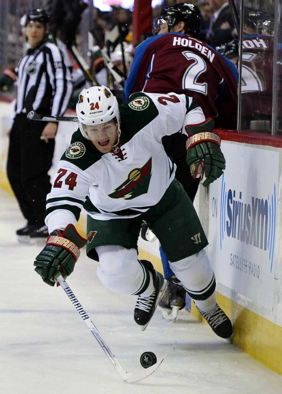 Minnesota Wild left wing Matt Cooke reaches to control the puck against the Colorado Avalanche in the first period of Game 2 of an NHL hockey first-round playoff series on Saturday, April 19, 2014, in Denver. (AP Photo/Jack Dempsey)