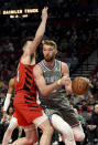 Sacramento Kings forward Domantas Sabonis, right, drives to the basket on Portland Trail Blazers forward Drew Eubanks, left, during the first half of an NBA basketball game in Portland, Ore., Wednesday, March 29, 2023. (AP Photo/Steve Dykes)