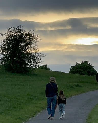 <p>Kate Hudson/Instagram</p> Kate Hudson and Rani Rose walk along a hillside