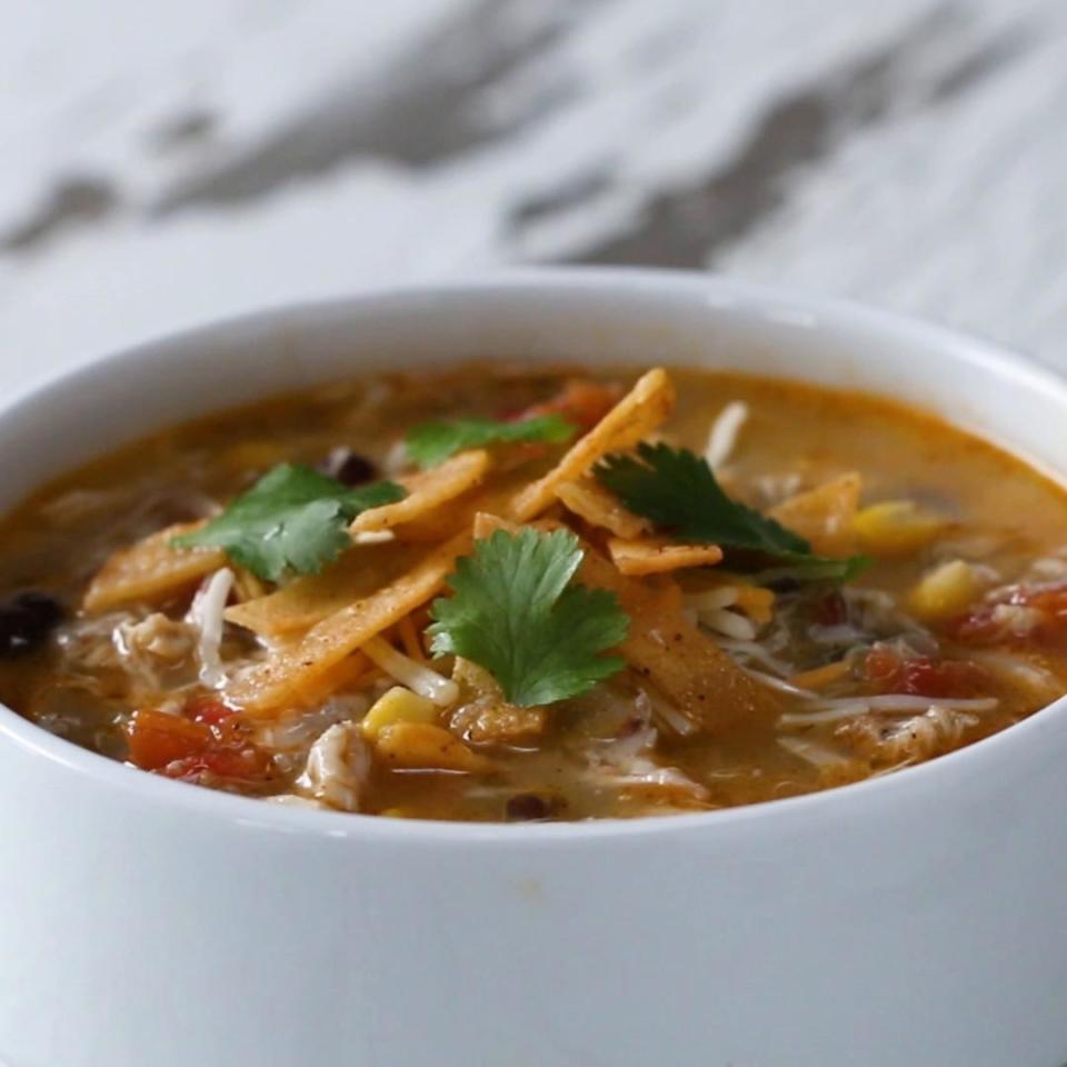 Pot of hot soup topped with chips