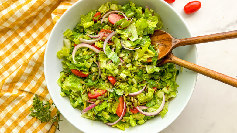 lettuce tomato salad in white serving bowl