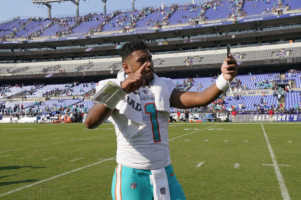 Miami Dolphins quarterback Tua Tagovailoa (1) takes a selfie on the field after defeating the Baltimore Ravens at an NFL football game, Sunday, Sept. 18, 2022, in Baltimore. The Dolphins defeated the Ravens 42-38. (AP Photo/Julio Cortez)